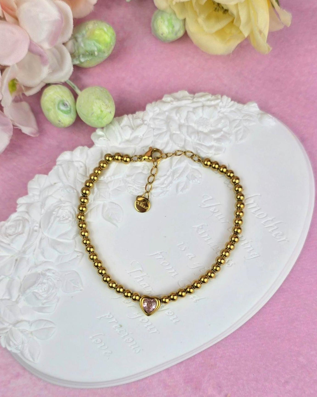 A Gold Plated Beaded Bracelet with a Pink CZ Heart stone . Stainless steel adjustable  bracelet