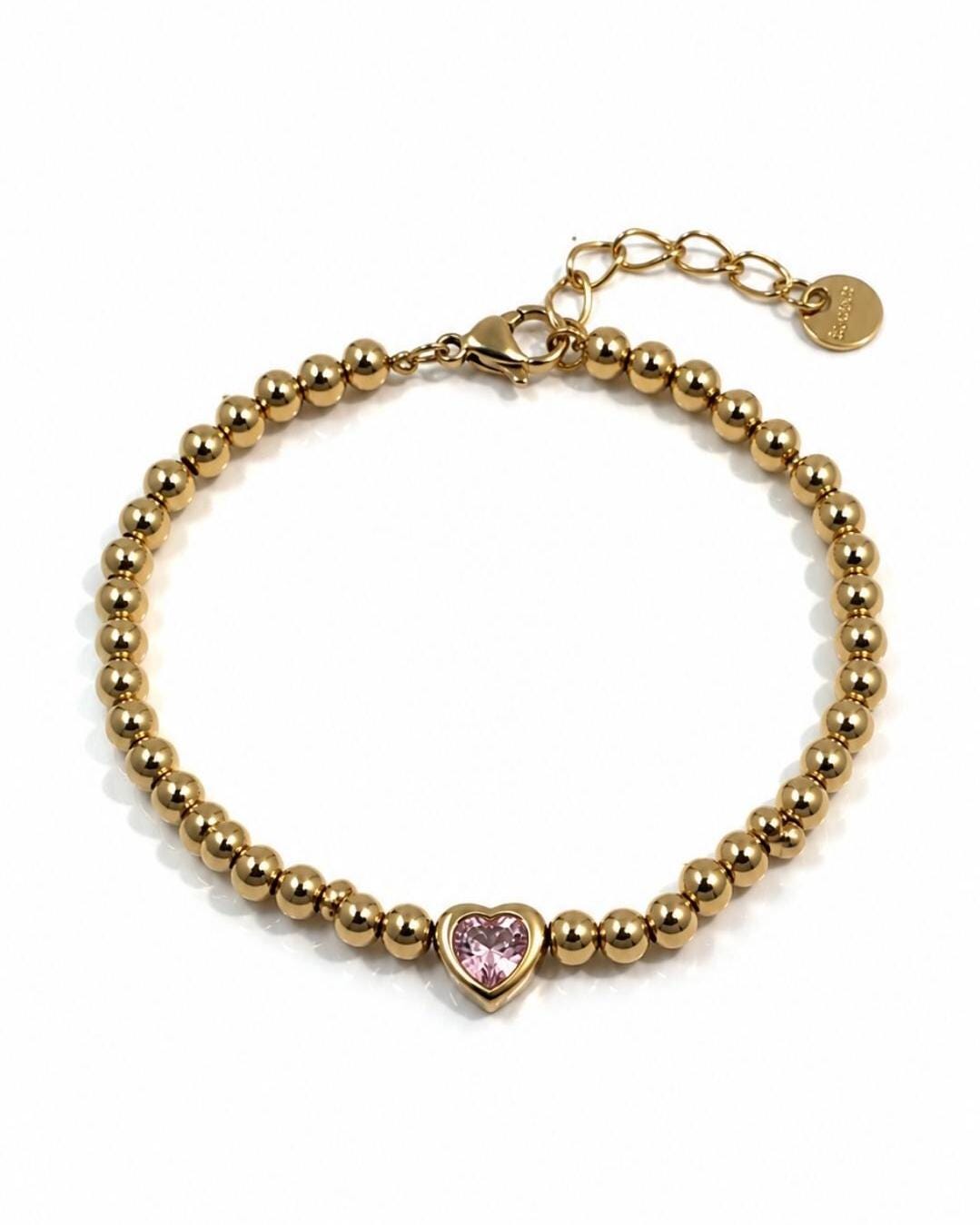 A Gold Plated Beaded Bracelet with a Pink CZ Heart stone . Stainless steel adjustable  bracelet